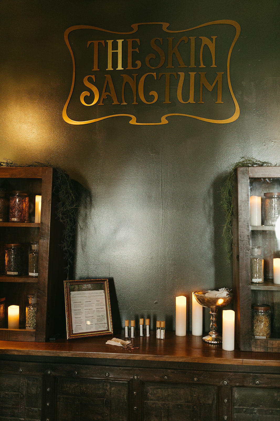 The skin sanctum gold sign on wall in Denver co