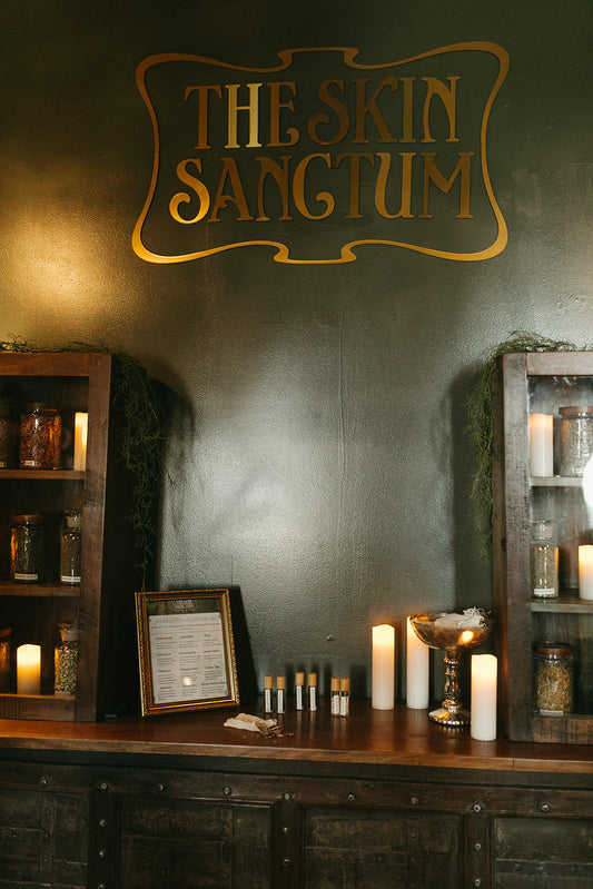 The skin sanctum gold sign on wall in Denver co