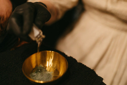 Mixing skincare ingredients in a gold bowl at the skin sanctum in denver