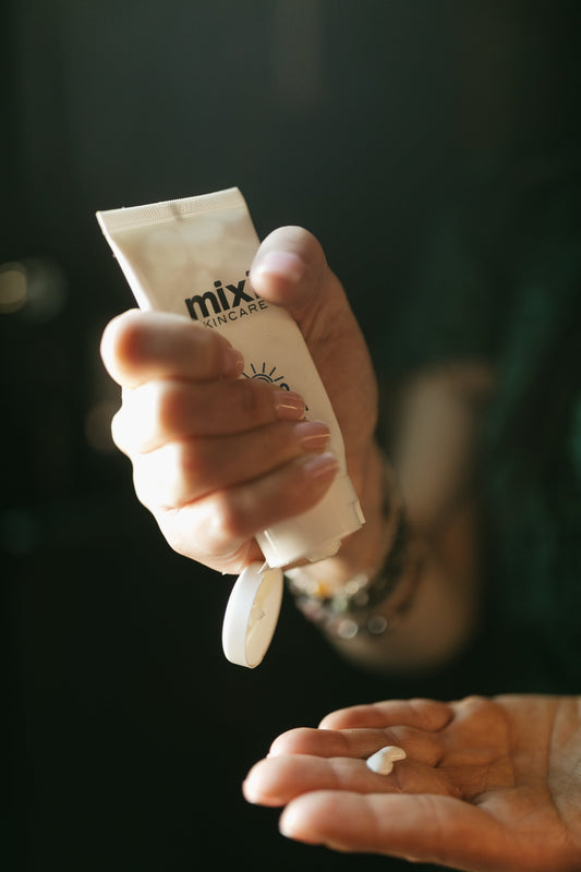 Mixi SPF being squeezed into a hand at the skin sanctum in denver