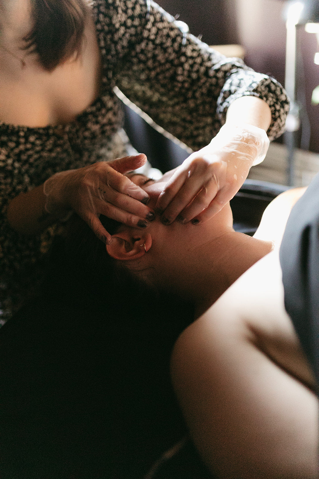 Woman receiving a personalized facial service in a Denver, CO spa