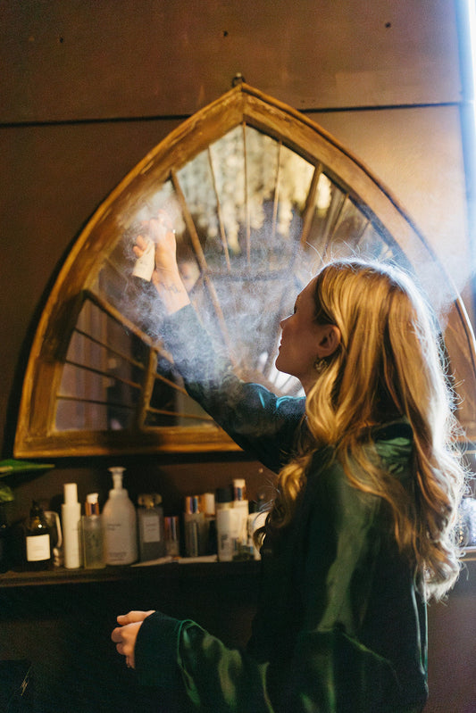 Spraying hyacyn mist from Hydrinity for acne control at the skin sanctum spa in denver