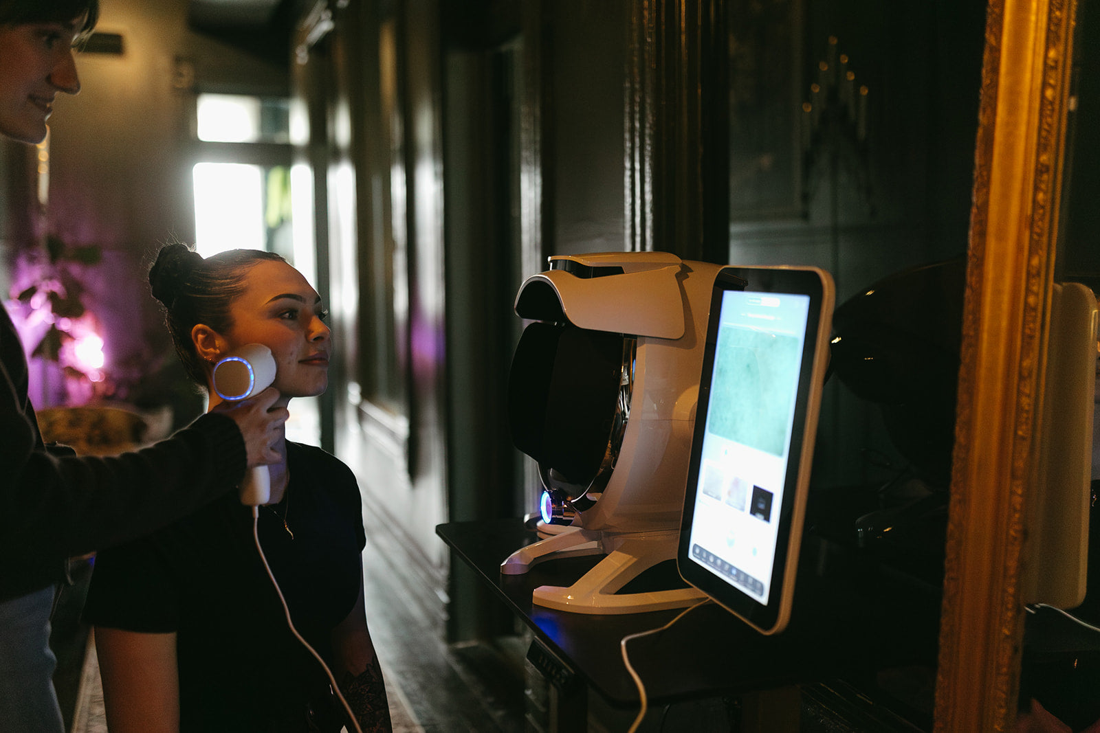 Person using a futuristic robot interface in a dimly lit room