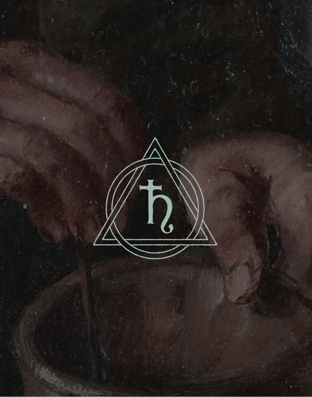 Close-up of a person's hands holding a small object with a symbol in the center.